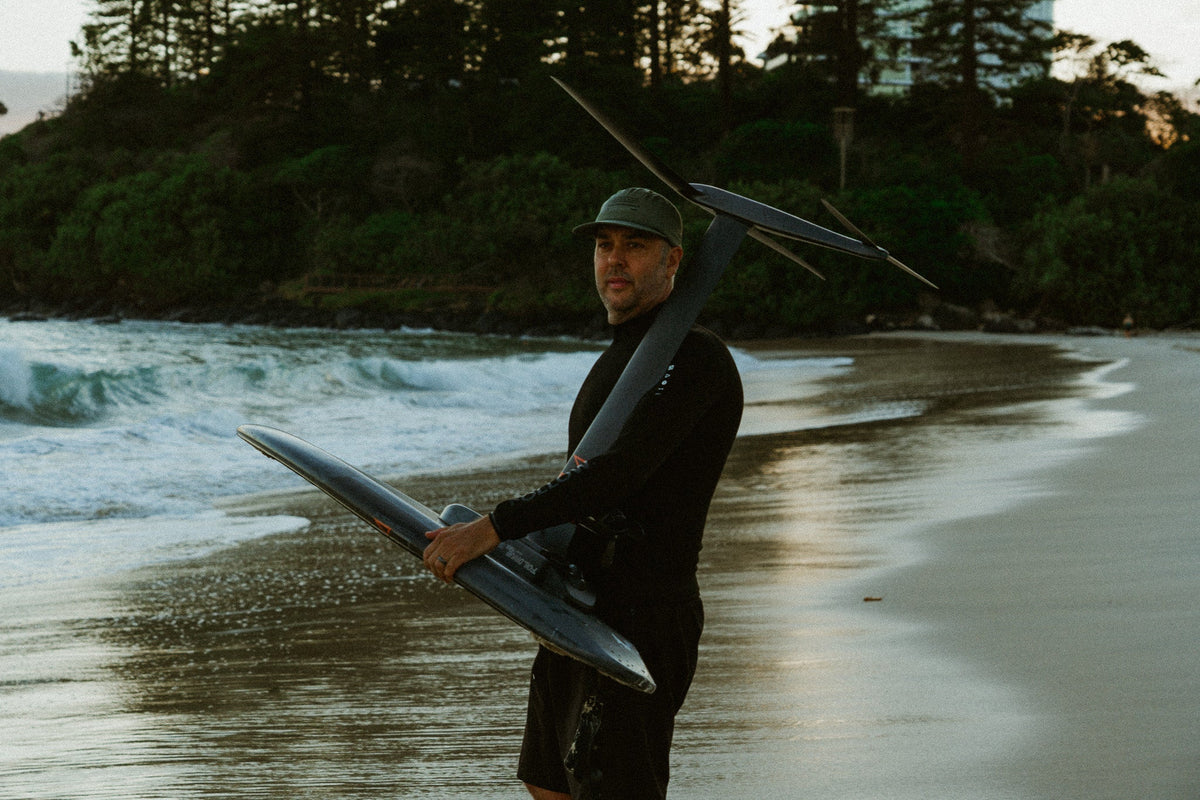 Follow founder Steve Anderson heading out for a seesion on his Foil Drive in the Follow P1 Oceana Wetty Top and Follow Welded Boardie in Black